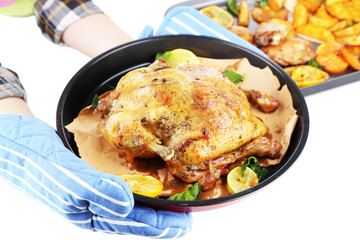 Woman holding pan with  homemade fried chicken  and vegetables