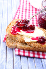 Delicious toast with jam on table close-up