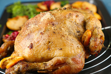 Whole roasted chicken with vegetables and fried potatoes