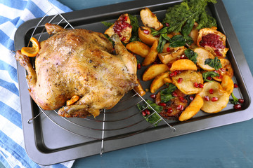 Whole roasted chicken with vegetables and fried potatoes