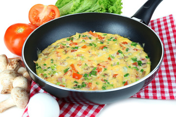 Omelet with vegetables close up