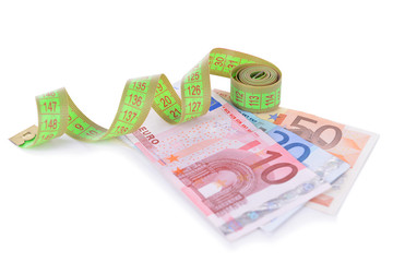 Tape measure with money isolated on white