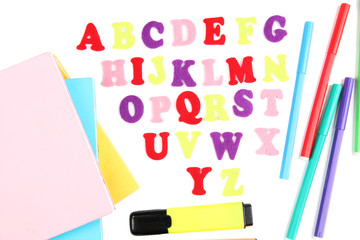 English alphabet, books and markers, isolated on white