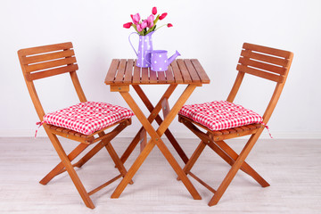 Garden chairs and table on white background