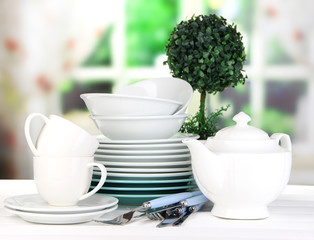 Obraz na płótnie Canvas Clean dishes on table on window background
