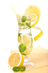 Glass of cocktail with lemon and mint isolated on white