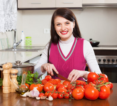  brunette woman slicing tomatoes