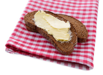 Slice of rye bread with butter, isolated on white