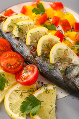 Delicious grilled fish on plate on table close-up