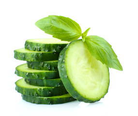 Sliced fresh cucumber with basil, isolated on white