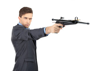 Young businessman with crossbow, isolated on white