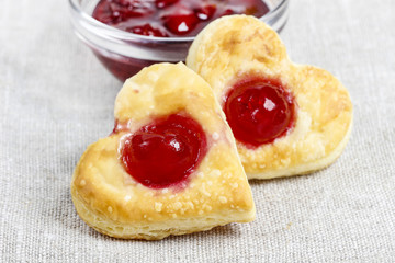 Puff pastry cookies in heart shape filled with cherries