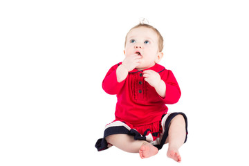 Cute baby girl in a red dress, isolated on white