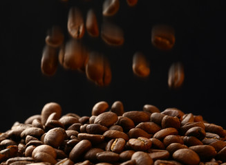 Brown coffee beans falling down
