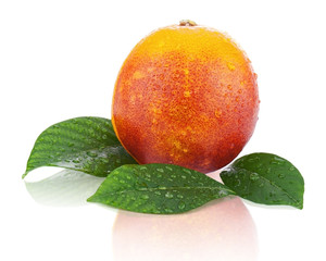 Blood orange with green leaves isolated on white background.