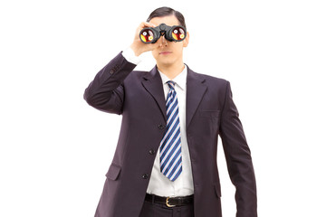 Male businessman watching through binoculars