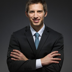Half-length portrait of business man with his arms