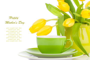 yellow tulips flowers with cup tea, on a white background. break