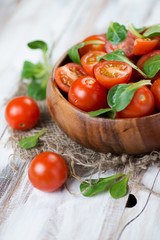 Cherry tomatoes and corn salad leaves, close-up