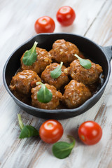 Frying pan with meatballs, vertical shot