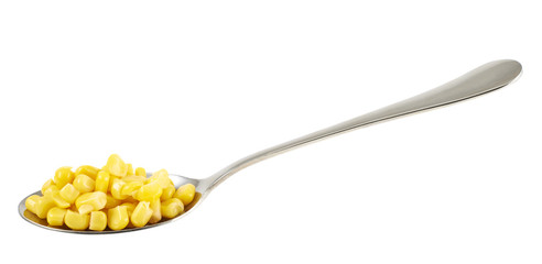 Steel spoon full of corn kernels isolated