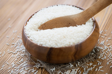 Wooden bowl with raw basmati rice, close-up
