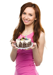 Young woman with anniversary cake