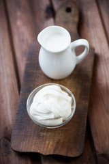 Freshly made sour cream, rustic wooden background