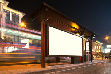 Blank billboard on bus stop at night - obrazy, fototapety, plakaty