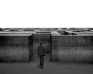 Rear view businessman walking toward to 3D concrete Maze