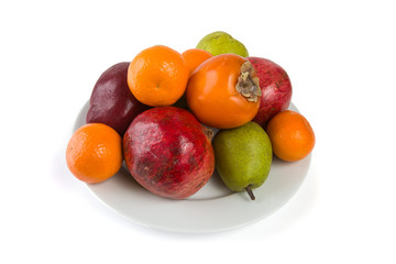 Plate full of fruits isolated on white