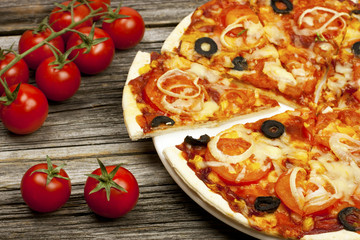 Delicious vegetarian pizza on a wooden surface