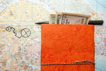 Travel Arrangement of Dollars, Map and notepad diary