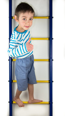 A child stands on a ladder on white background
