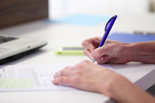 hands writing with pen