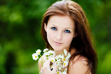 Beautiful Blue Eyed Woman Holding Flowers and smiling to camera - 61251739