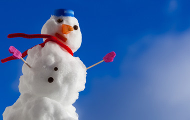Little happy snowman with pink gloves outdoor. Winter season.