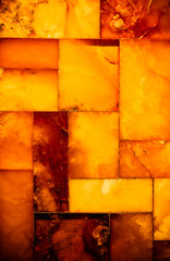 Closeup of golden amber mosaic as background or texture. Gem.