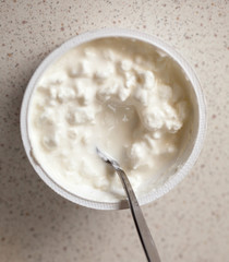 Cottage cheese and teaspoon. Diet and healthy nutrition.