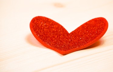 one decorative red heart on wood background