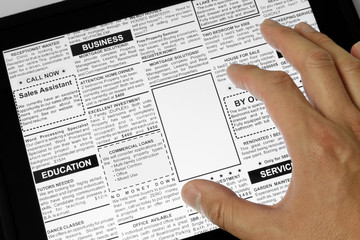 Obraz premium Touchpad and newspaper