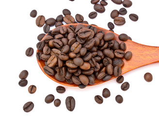 Fresh coffee beans with wooden spoon isolated over white