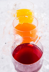 Mango, orange and grape fruit juices in short glass