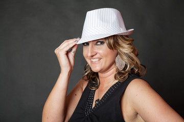 Young white woman wearing white pinstripe hat