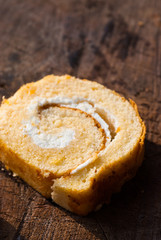roll cake on wooden table