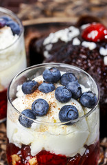Layer strawberry, blueberry and muesli dessert in glass goblet