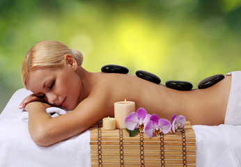 Spa Stone Massage. Blonde Woman Getting Hot Stones Massage