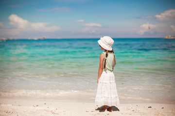 Fototapeta na wymiar Adorable little girl walking on tropical white beach