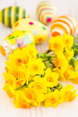 Obraz na płótnie Canvas Yellow daffodils with easter eggs