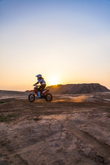 Fototapeta na wymiar dusty desert racer on a motorcycle